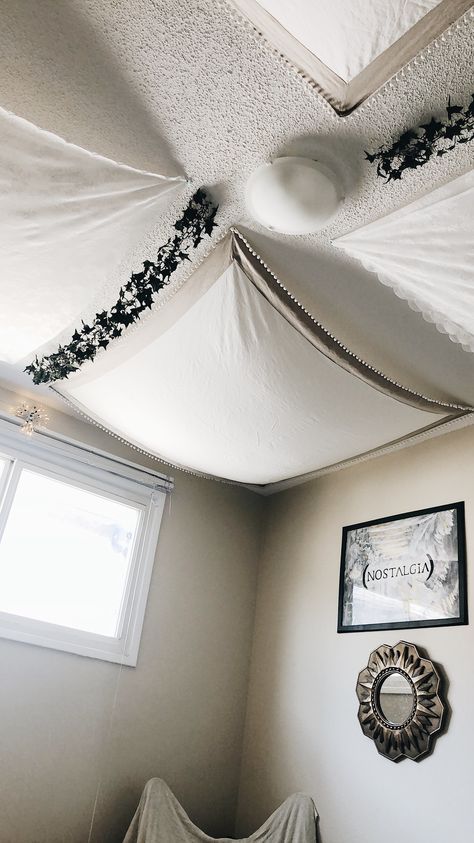 Blanket Fort Vibes • There are plenty of curtains in the AS-IS Section of Ikea and other home decor stores. I took 2 fabrics I found in that section and folded them into squares. Using white, green, clear and black push pins, I pinned the fabrics onto the ceiling. This creates very tiny unnoticeable holes in the ceiling, making it ideal for renter situations! It gave my bedroom some character at a very minimal cost. Blanket On Ceiling, Hebrew Holidays, Apartment Bedrooms, Blanket Fort, Apartment Life, Push Pins, My Bedroom, Apartment Inspiration, Home Decor Store