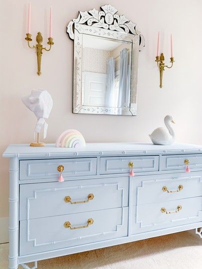 our nursery design was based around this vintage bamboo dresser that we repainted in the perfect blue to accent the pink walls... perfect combo for a baby girl.  We are so obsessed with the vintage gold pineapple sconces... White Dresser With Blue Drawers, Baby Girl Nursery Accent Wall, Girl Nursery Accent Wall, Blue Nursery Girl, Baby Blue Bedrooms, Faux Bamboo Dresser, Blue Girls Rooms, Girls Blue Bedroom, Bamboo Dresser