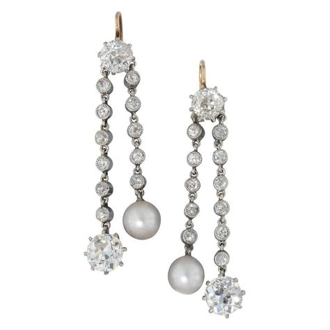 A pair of Edwardian natural pearl and diamond drop earrings, each earring set with an old brilliant-cut diamond surmount, weighing a total of 1.22 carats, suspending two diamond-set chain runs of alternating lengths, with natural pearl and old brilliant-cut diamond drops, the pearls weighing 2.80 carats with Anchor certificate number 2/985034, the diamonds weighing 1.69 carats for the pair, set in platinum with yellow gold hook fitting, measuring approximately 4.2 x 1.1cm, gross weight 5.9 grams Diamond Pearl Earrings, Pearl And Diamond Earrings, Jewellery Shop, Sparkle Earrings, White Gold Earrings, Natural Pearl, Antique Earrings, Diamond Drops, American Diamond