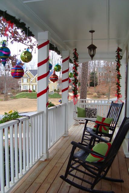 I like the use of red ribbon around the posts. I think I may alternate garland and red ribbon around mine. Porch Christmas Lights, Neutral Nature, Outside Christmas Decorations, Christmas House Lights, Love Decorations, Christmas Front Porch, Christmas Porch Decor, Front Porch Decorating, Front Porch Christmas Decor