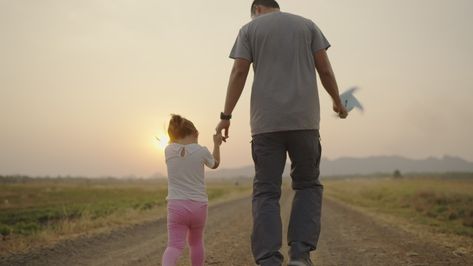 4k Video slow-motion, An Asian father took his daughter's hand for a walk. The right-hand holds a turbine During the sunset Family concept. Model Release, Free Stock Video, 4k Video, Photo Template, Popular Videos, Free Videos, The Sunset, A Walk, Right Hand