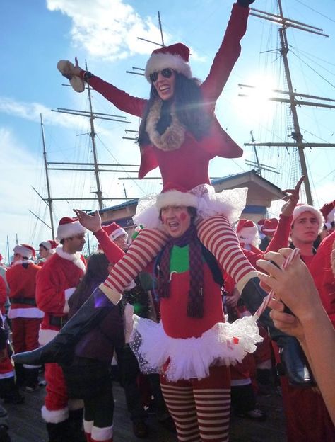 Santacon costumes by Emily Kammeyer and Trevor Sumner. #santacon #costume #holiday #christmas Funny Christmas Costumes Hilarious, Santa Con Outfits Nyc, Pregnant Christmas Costume, Christmas Party Costume Ideas Funny, Santa Con Outfits, Santa's Elf Costume, Santacon Outfit, Santa Claus Women Costume, Santacon Nyc