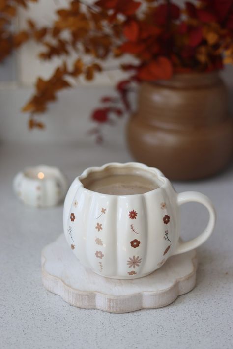 What We Like   	Autumn decoration  	Stoneware  	Large capacity  If you're looking for a new cute mug this season our large Pumpkin Mug finished in with a water colour floral detail is the perfect choice!  Crafted from durable stoneware, this 650ml capacity mug makes it the perfect choice to wrap your hands around this Autumn.  If you love Autumn decor these quality pumpkin mugs are the must have addition to your autumn homeware collection. White Pumpkin Mug, Pumpkin Mug Painting, Autumn Mug Painting Ideas, Autumn Mug Painting, Fall Ceramic Painting Ideas, Autumn Ceramics Ideas, Pottery Painting Autumn, Fall Mug Painting Ideas, Autumn Pottery Painting