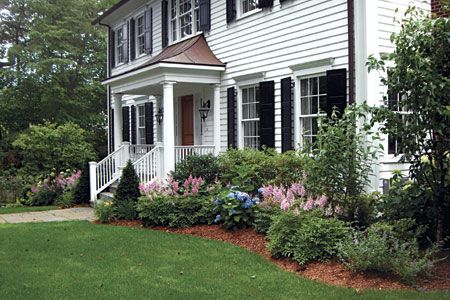 Foundation Planting Basics The plantings closest to your home should play up its assets and soften its hard edges White House With Black Shutters, House With Black Shutters, Evergreen Landscape Front Yard, Pieris Japonica, Evergreen Landscape, Porch Landscaping, Porch Styles, Black Shutters, House Foundation