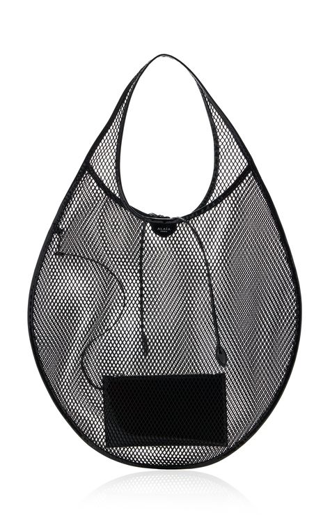 Find ALAÏA Leather-trimmed Mesh Tote Bag Os on Editorialist. The ALAÏA Leather-Trimmed Mesh Tote Bag is crafted from laser-cut mesh and trimmed with leather. This tote has a semi-sheer body fashioned into a circular silhouette. It features a top handle and a tie detail. Tote Bag Packaging, Ethereal Dramatic, Alaia Bag, Creative Tote Bag, Edgy Bags, Totes Ideas, Statement Bags, Azzedine Alaïa, Mesh Pouch