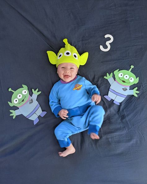 3 month old baby laughing and laying on dark blue background wearing a Toy Story alien costume. Toy Story Alien Infant Costume, Disfraz Toy Story, 3 Month Photos, Month Milestones, Infant Costume, Month Pictures, Toy Story Baby, Toy Story Alien, Baby Costumes