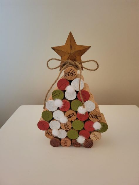 Elevate your holiday decor with my unique handcrafted Christmas trees. Created from recycled wine corks. Each piece is hand- painted  adorned  with snow balls then topped with a metal star &jute bow. Adding a touch of charm and eco-friendliness to your holiday celebrations. Celebrate the season with this charming tree or great to give as a gift. Things To Make Out Of Corks, Wine Christmas Decorations, Wine Cork Flowers, Wine Cork Trees, Cork Snowflakes, Crafts With Wine Corks, Oktoberfest Crafts, Wine Cork Christmas Crafts, Cork Upcycle