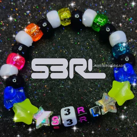 s3rl dj kandi bracelet !!! my favorite dj :3 ♡ handmade with love by me! ♡ freebies with every order! thank you for your support <33 🩷🌸❤️🌸🧡🌸💛🌸💚🌸💙🌸💜 shares are greatly appreciated! you are helping me grow my small business <3 PLUR!! 🫶🌈 #kandi #kandikid #kandicuff #kandibracelet #kidcore #scenecore #dreamcore #pinkcore #kawaii #decora #fairykei #rainbowcore #s3rl #djs3rl Kandi Organization, Band Kandi Bracelets, Scene Kid Bracelets, Band Kandi, Scenecore Kandi, Jewelry Pics, Kandi Inspo, Estilo Punk Rock, Diy Kandi Bracelets