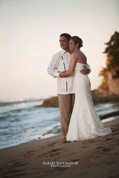 Beach bride and groom in a Debra Torres guayabera. #beachweddingattire #beachbride #beachgroom Beach Bride And Groom, Destination Wedding Attire, Beach Groom, Beach Wedding Style, Romantic Suspense Books, Beach Wedding Attire, Amish Community, Guayabera Shirt, Suspense Books