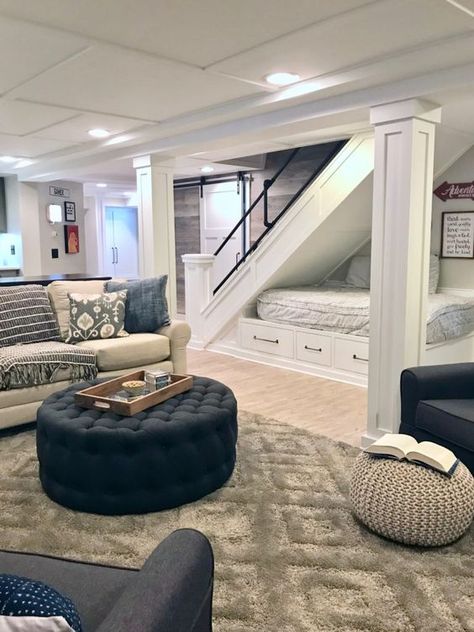 A HGTV fixer Upper basement remodel with shiplap wood walls, sliding barn doors, and industrial chic accents. A cozy reading and lounging nook was created under the stairs with extra storage. Cost To Finish Basement, Cool Basement Ideas, Cozy Basement, Basement Apartment, Basement House, Small Basements, Basement Makeover, Basement Bedrooms, Basement Flooring