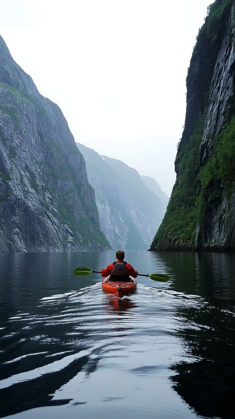 Aries kayaks through Norway's majestic fjords, navigating steep cliffs and calm waters, embracing adventure in a breathtaking landscape. Norway Fjords, Calm Waters, Kayak Adventures, Calm Water, Kayaks, Kayaking, Norway, Travel Destinations, Water