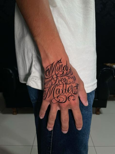 Mind Over Matter Tattoo Design, Hand Tattoos For Guys Words, Traps Tattoo Men, Letter Hand Tattoo, Trap Tattoo Ideas, Hand Tattoo Lettering, Writing On Hand Tattoo, Gangsta Tattoos Men Design, Hand Tattoos For Guys Men