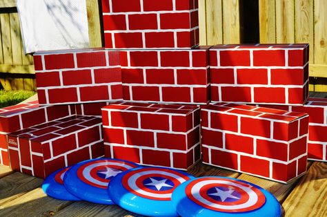 Super Hero Party....I got cardboard brick blocks ($10 at Wal-Mart but I got mine on clearance at Wal-Greens!).  They built a wall and either busted through the wall with their super strength, or knocked it down with their Captain America shields (frisbees). Superhero Pool Party, Cardboard Superhero, Cardboard Bricks, Captain America Birthday Party, Captain America Party, Super Hero Party, Captain America Birthday, Superheroes Party, America Party