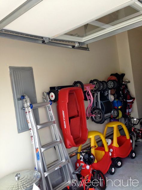 Source: SweetHaute.blogspot.com 9. Garage Track System Let’s not forget about the other play area, your garage. I personally have a Cozy Coupe, tricycle, baby doll stroller, and variety of other ridable toys that park right next to my grown up car. If we get many more toys, there’s going to be a turf war. TheContinue Reading... Outdoor Toy Storage, Garage Boden, Baby Toy Storage, Garage Floor Paint, Toy Garage, Garage Organize, Garage Shed, Radio Flyer, Garage Makeover