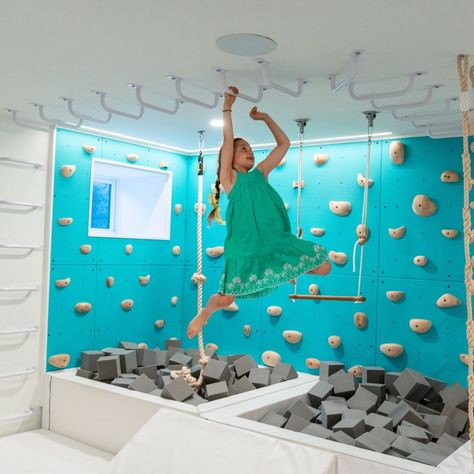 37 Playroom Decor Ideas for Endless Fun - HouseResults Indoor Rock Wall For Kids, Indoor Monkey Bars For Kids, Rock Climbing Wall Playroom, Monkey Bars Indoor, Downstairs Playroom, Diy Monkey Bars, Kids Indoor Play Area, Kids Indoor Gym, Indoor Monkey Bars