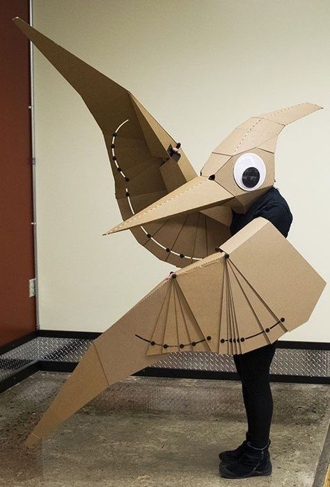 Figure 1. Pteranodon costume with wings that fold in the plane of the wing. Cardboard Costumes Diy, Pterodactyl Costume, Cardboard Costume, Cardboard Mask, The Mask Costume, Cardboard Sculpture, Dinosaur Costume, Cardboard Art, A Dinosaur