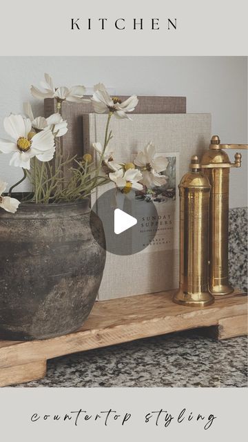 Evelyn Hernandez on Instagram: "Kitchen Counter Styling ✨  My kitchen is currently a space I am not fully in love with but that will not stop me from making it beautiful with some decor! Since my countertops are so busy, its very hard for anything to stand out on its own. Trivets and trays are my best friend when it comes to styling this space and this wooden trivet from @luxebco is absolutely perfect. Definitely elevated everything placed on top of it.   Stay tuned for how I styled the rest of my kitchen in this weeks Youtube video 🤍   Comment “Links” to shop this post!   #kitchenstyling #kitchencounterstyling #kitchendesign #kitchenhomedecor #kitchendecor #granitecountertops #granitecounterstyling #woodentrivets #woodenrisers #wooddecor #vintagedecor #rusticdecor #stylewithme #whatiboug Kitchen Styling Countertops, How To Decorate Kitchen Counters, Counter Styling, Kitchen Counter Styling, Kitchen Island Centerpiece, Kitchen Countertop Decor, 2024 Kitchen, Instagram Kitchen, Countertop Decor