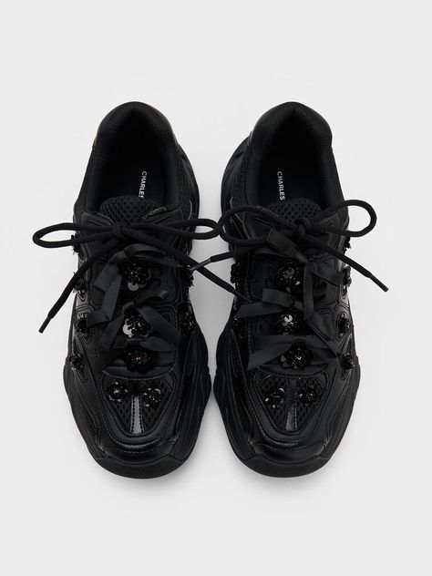 The Gaskell chunky sneakers get a feminine coquette update with the addition of dainty flower embellishments and bows on the laces. The black-on-black combination creates an edgy aesthetic that is in contrast with the daintier details, making these shoes especially great for the girlies who lean towards a cool streetstyle vibe. The chunky soles add to their visual appeal, while offering a comfortable height boost. Flower Embellishments, Edgy Aesthetic, Chunky Sneakers, Sneakers Black, Embellishments, Street Style, Sneakers, Black