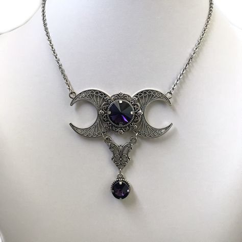 "This triple moon necklace is made with antiqued silver plated filigrees and crescent moons, adorned with sparkling DEEP PURPLE glass crystals.  Centerpiece is 2 1/2\" wide and 2 1/2\" tall. It is worn with soldered stainless steel cable chain. Necklace is adjustable 15-18\" with a lobster clasp and chain extender.  If you would like a different length, please send us a message. Matching earrings are listed in our store in a variety of stone colors. If you don't see items with a color you want, Goth Masquerade, Goth Barbie, Purple Goth, Antique Silver Necklace, Halloween Goth, 2024 Halloween, Barbie Wedding, Purple Gems, Cable Chain Necklace