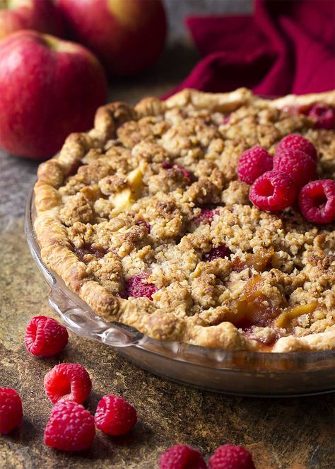 My homemade apple raspberry pie is the best! It's packed full of sliced apples and fresh, sweet raspberries then covered with a buttery streusel crumb topping. Perfect for holidays, Christmas, and Thanksgiving. | justalittlebitofbacon.com #christmasrecipes #thanksgivingrecipes #holidayrecipes #dessertrecipes #applepie #raspberrypie #pie Apple Raspberry Pie Recipes, Raspberry Pie With Crumb Topping, Raspberry Apple Pie, Apple Raspberry Pie, Raspberry Crumble Pie, Crumb Top Apple Pie Recipe, Apple Crumb Pie Recipe, Caramel Crumble, Deep Dish Apple Pie