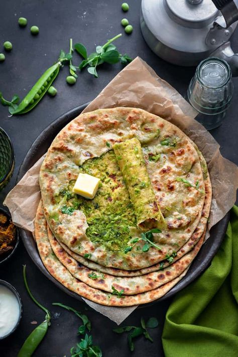 Overhead shot of spicy Matar paratha on black plate with top paratha cut open to show the peas filling. Peas Paratha, Naan Recipes, Stuffed Flatbread, Indian Food Photography, Fresh Peas, Winter Breakfast, Peas Recipe, Paratha Recipe, Flat Breads