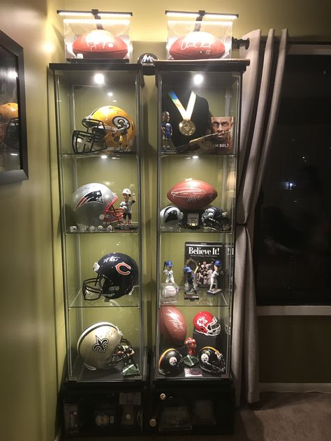 Sports display case Sports Collectibles Display, Sport Display Ideas, Basketball Display Ideas, Displaying Sports Memorabilia, Sports Memorabilia Display Ideas, Football Display Ideas, Sports Memorabilia Display Wall, Football Memorabilia Display, Memorabilia Display Ideas