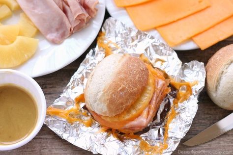 These Hot Ham and Pineapple Campfire Sandwiches are a delicious and easy tin foil recipe. Plus cleanup is a breeze! (You can even bake these in the oven too!)     *This post is brought to you … Foil Recipes, Tin Foil Meals, Camping Recipes Breakfast, Easy Camping Breakfast, Tin Foil Dinners, Campfire Breakfast, Camping Dishes, Camping Hacks Food, Foil Dinners