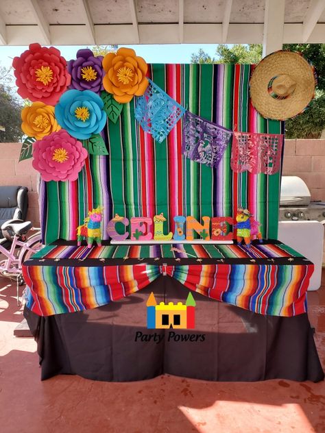 Zarape Backdrop with Paper Flowers, papel picado, and sombrero. Main table with black linen and 2 zarape runners. Great for fiesta theme party and mexican theme party. Paper Flowers Mexican Fiesta Party, Mexican Main Table Decorations, Mexican Paper Flowers Backdrop, Mexican Birthday Backdrop, Main Table Quinceanera Mexican Theme, Fiesta Theme Backdrop Ideas, Papel Picado Backdrop, Mexican Backdrop Ideas, Mexican Party Backdrop