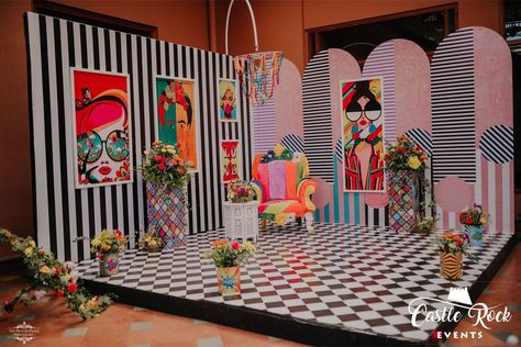 The monochrome print really brought out the vintage Pop Art prints for this Bride seating! Colourful and quirky through floral, furniture, prints and other accents adding character. Don't miss the colourful pom pom Chandelier! #popart #popartdecor #popartstage #popartmehendidecor #popartbridalseating #colourfuldecor #quirkydecor #colourfulchandelier #funcolourfuldecor #funcolourfulmehendidecor #popartpictureframes #popartpaintings #indianwedding #destinationwedding #goaweddings #weddingsingoa Pop Art Centerpiece, Pop Art Wedding Decor, Pop Art Party Decoration, Wood Backdrop Wedding, Pop Art Furniture, Pop Art Wedding, Pop Art Party, Pop Art Prints, Stand Feria