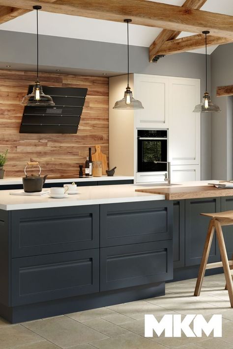 A traditional kitchen at its core, but with a modern twist. This kitchen uses a two-tone colour scheme with navy blue and white to create a contemporary feel, along with its handleless doors and sleek white worktops. But, the use of natural wood throughout emphasises character and a modern farmhouse style. Explore our full range of kitchens or book a free design appointment by visiting mkm.com Kitchen Navy And White, Navy And White Kitchen, Kitchen Navy, White Worktop, Navy Kitchen, Free Kitchen Design, Modern Farmhouse Kitchen, Shaker Style Doors, Kitchen Gallery