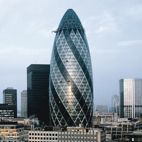 Rising 180 meters above London's skyline, the 30 St Mary Axe, also known as The Gherkin, boasts 41 floors of architectural brilliance. Capturing the fusion of art and commerce in the heart of the city's financial district. Gherkin London, The Gherkin, London Skyline, Financial District, St Mary, In The Heart, London, Architecture, Building