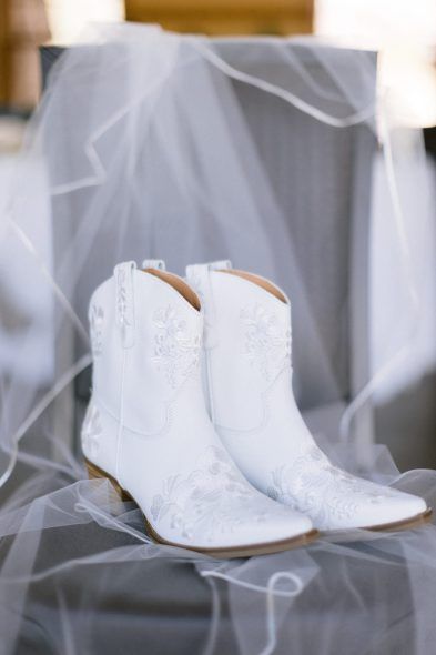 In true mountain girl fashion, Emma changed into delicate white-laced cowgirl boots. Cowgirl Boots For Wedding Dress, White Boots For Wedding, White Cowgirl Boots With Wedding Dress, Womens Wedding Boots, Cowgirl Boots Bride, White Cowboy Boots Bride, Bridal Cowboy Boots Wedding, Wedding Shoes Cowgirl Boots, Cowboy Boot Bride