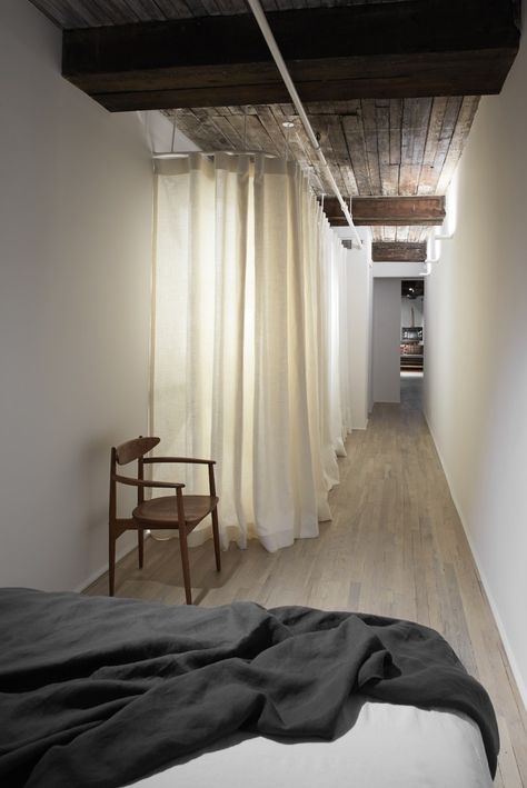 Closets behind curtain can be back lit for drama | Remodelista Curtain Room Divider, Tiny Studio Apartments, Tribeca Loft, Closet Curtains, Diy Room Divider, Boutique Ideas, Tiny Studio, New York Apartment, Nyc Apartment