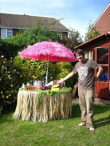 Tacky Tiki: gotta have a pink umbrella! Luau Backdrop, Margarita Ville, Tropical Party Foods, Hawaiian Party Food, Tiki Wedding, Tacky Wedding, Tiki Umbrella, Tiki Oasis, Bachelorette Cruise