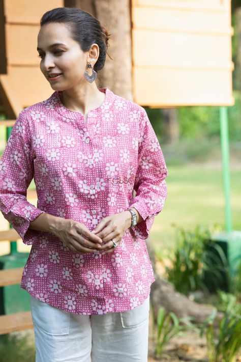 If you are looking for something light but professional, this shirt-style Kurti would be perfect for you. Made from 100% cotton, this Kurti lets you breathe, feels light and comfortable. And when it comes to the looks, the hand block print on pink is just magic to the eyes. The kurti comes with front buttons and 3/4th sleeves and are perfect match with your denim jeans or white pants. Shirt Style Kurti, Cotton Tops Designs, Style Kurti, Just Magic, Short Kurti, Desi Fashion Casual, Half Sleeve Shirts, Cotton Linen Dresses, Linen Short