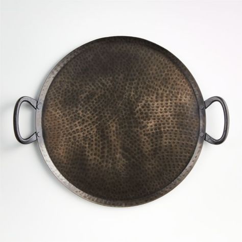 Our Feast round hammered iron serving platter is a great way to serve appetizers, finger foods or ethnic specialties to a big group with high-impact style. Each large-scale server is handcrafted from iron, hand-hammered into its own unique pattern. Practical sturdy loop handles complete the traditional look.Looking for gift ideas? Browse more gifts under $50.  • 100% hand-hammered iron • For serving only; not intended as a cooking utensil • Hand wash • Made in India Hammered Iron, Halloween Centerpiece, Wooden Serving Trays, Glass Centerpieces, Serving Trays With Handles, Round Tray, Centerpiece Bowl, Serving Platter, Serving Platters