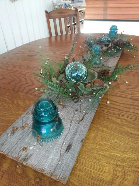 my barn wood insulator Christmas centerpiece table with vintage silver bells. Blue Insulators Ideas, Insulator Crafts, Insulator Ideas, Christmas Centrepiece Table, Centerpiece Table, Christmas Centerpieces Diy, Glass Insulators, Christmas Centerpiece, Silver Bells