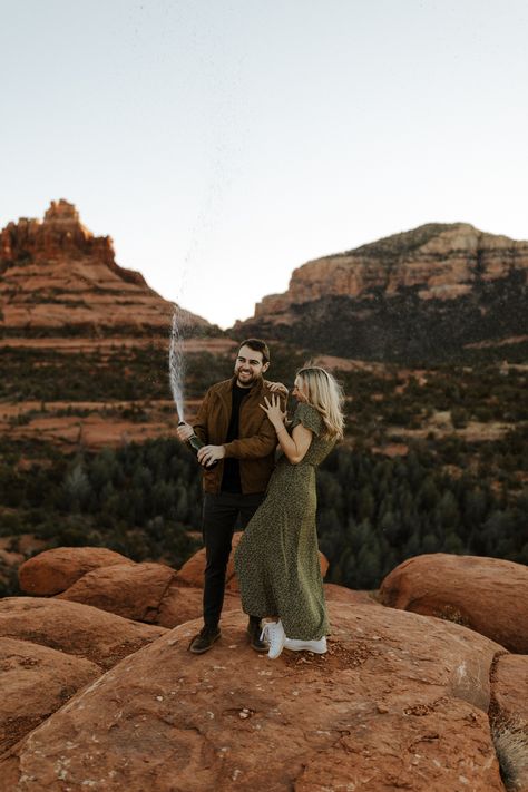 Arizona Mountain Engagement Photoshoot | Champagne Pop Photo Ideas | AZ Engagement Photography. Arizona engagement photo ideas are always the perfect place to start your engagement photo inspiration search! Get inspired with AZ desert engagement photos, engagement photoshoot ideas in Arizona, AZ engagement photos outfits, and engagement photo locations Arizona! Book us, a husband and wife duo, for your summer Arizona engagement photoshoot at kalimphotos.com Superstition Mountains Photoshoot, Az Engagement Photos, Sedona Engagement Pictures, Mountains Photoshoot, Engagement Photos Grand Canyon, Engagement Photo Arizona, Red Rock Canyon Engagement Photos, Phoenix Arizona Engagement Photos, Joshua Tree Engagement Photos