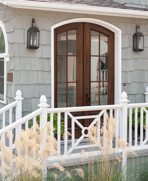 If you're looking to add something extra to your deck these railing ideas are just what you need. Whether you prefer an ornate or simple deck railing, these designs will dress up your deck with long-lasting appeal. #renovationideas #remodeltips #deckideas #deckrailing #bhg Exterior Door Ideas, Cottage Style Front Doors, Wood Deck Railing, Cottage Front Doors, Simple Deck, Deck Railing Design, Railing Ideas, Side Porch, Deck Railing