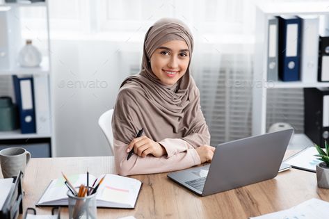 Millennial Muslim Girl In Headscarf Posing At Workplace In Modern Office by Prostock-studio. Business Career For Islamic Women. Portrait Of Millennial Muslim Girl In Headscarf Posing At Workplace In Modern Office #AD #Posing, #Workplace, #Modern, #Headscarf Inspirational Quotes About Time, Female Manager, Business Pictures, Hijabi Aesthetic, Digital Tablet, Graphic Designer Portfolio, Business Career, Female Doctor, Drinking Coffee