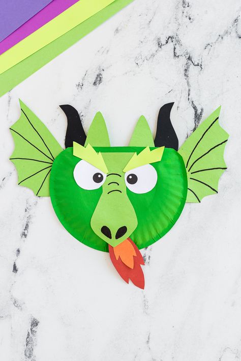 A fierce yet simple paper plate dragon craft activity that kids of all ages are sure to love any time of year. Dragon Arts And Crafts For Kids, Paper Plate Dragon, Dragon Craft, Dragon Plate, Dragons Love Tacos, Dragon Hats, Dragon Mask, Dragon Crafts, Teaching Lessons