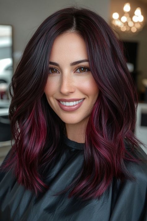 Looking to spice up your hair game? Dark red hair is the perfect way to add a bold and sultry touch to your look. 💋 #darkredhair #hairinspo #boldbeauty #sultryvibes #hairgoals #redhot 🔥 Whether you opt for a deep burgundy or a fiery auburn, this color is sure to turn heads and make a statement. 💁‍♀️ #statementhair #hairtransformation Don't be afraid to go dark and embrace your inner vixen with dark red hair. 💄 #vixenvibes #haircolor #confidenceboost #beauty #hairtrends Hair Color Ideas For Brunettes With Red Burgundy Dark Brown, Cool Tone Burgundy Hair, Dark Brown Hair With Red Streaks, Black Cherry Hair Color Brown Skin, Vampire Hair Color, Red Streaks In Hair, Dark Brown Hair With Red Balayage, Hair Red Underneath, Burgundy Balayage Brunettes