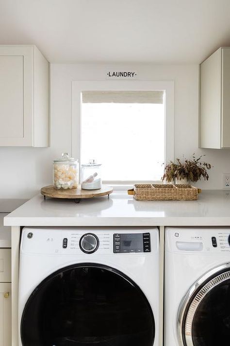 Enclosed White Front Load Washer and Dryer Under Window - Transitional - Laundry Room Washer Dryer Countertop, Playroom Lounge, Taupe Flooring, Salt Interiors, Transitional Laundry Room, Grey Laundry Rooms, Vintage Faucet, Pure Salt Interiors, Blue Laundry Rooms