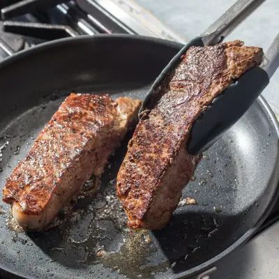 The Easiest, Cleanest Way to Sear Steak | Cook's Illustrated Cooks Illustrated Recipes, Strip Steaks, Donut Toppings, Caramel Chocolate Bar, Cookie Toppings, Caramel Tart, America's Test Kitchen Recipes, Kitchen Recipe, America's Test Kitchen