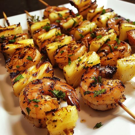 Grilled Jerk Shrimp and Pineapple Skewers 🍤🍍 Experience the perfect blend of spicy and sweet with these Grilled Jerk Shrimp and Pineapple Skewers. This dish is ideal for a summer barbecue or a flavorful dinner. Ingredients: 1 lb large shrimp, peeled and deveined 2 cups fresh pineapple chunks 3 tablespoons jerk seasoning 2 tablespoons olive oil 2 tablespoons lime juice 1 tablespoon honey Fresh parsley or cilantro, chopped for garnish Wooden or metal skewers Preparation: Prepare the Marinade: ... Jumbo Shrimp Skewers, Chicken And Shrimp Skewers, Grilled Jerk Shrimp, Shrimp And Pineapple Skewers, Skewers On The Grill, Garnishing Ideas, Shrimp And Pineapple, Grilled Skewers, Barbecue Skewers