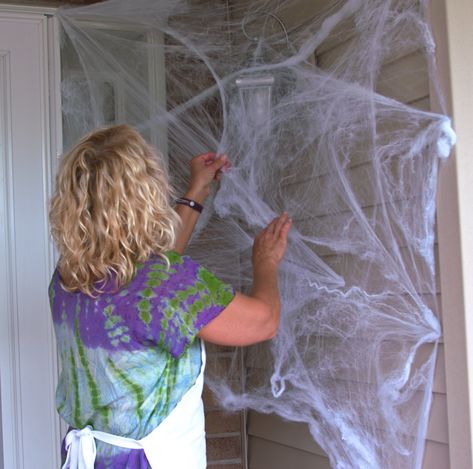 Cotton Spider Web Decoration, How To Put Up Spider Webbing, Spider Webbing For Halloween, Window Spider Web Diy, Decorating With Spider Webs, Decorating With Spiders For Halloween, Front Porch Spider Web Decor, Spider Web Door Decoration, Spider Web Front Door