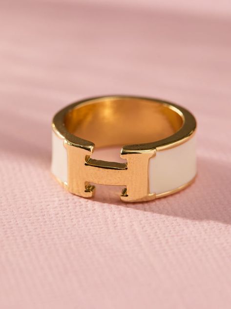 This elegant H enamel band ring is a stylish and effortless accessory to spice up your look. The ring's sleek, minimalist design features a single band of vibrant enamel. This versatile ring is perfect for everyday wear and it makes a great gift for anyone who appreciates timeless elegance and modern design. White Enamel Ring, Senior Ring, Senior Rings, Hermes Ring, Preppy Jewelry, Wrist Jewelry, Fancy Rings, Ring Stack, Unique Gifts For Women