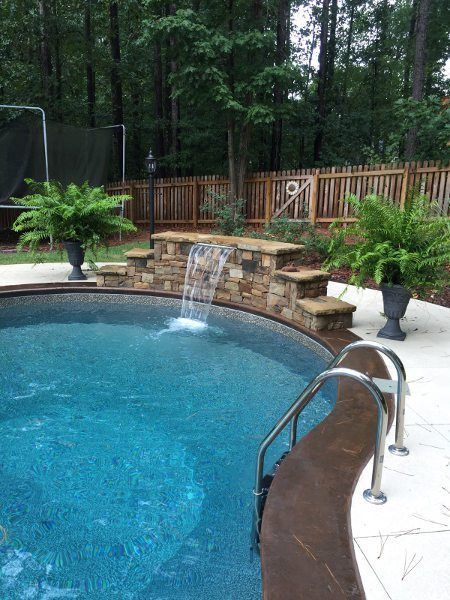 Vinyl with Sheer Descent Waterfall.  Notice - no tile border on liner.  Stamped & stained coping. By Aqua Fun. Ideas De Piscina, Swimming Pool Waterfall, Pools Backyard Inground, Swimming Pool Landscaping, Luxury Swimming Pools, Pool Water Features, Pool Remodel, Swimming Pool House, Pool Landscape Design