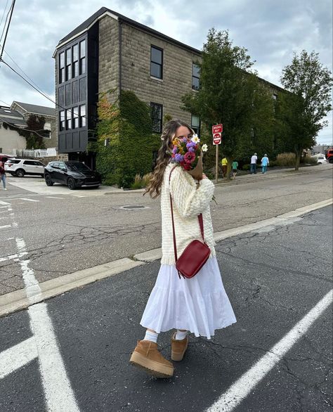 fall maxi skirt outfit rory gilmore sweater platform mini uggs inspo flower boquet brown paper inspo autumn vibes Long Dress And Uggs Outfit, Ugg Spring Outfit, Maxi Skirt And Sweater Outfit Fall, Ugg And Skirt Outfit, Uggs Dress Outfit, Uggs With Skirt Outfit, White Skirt And Sweater Outfit, Fall Outfits Maxi Skirt, Skirt With Uggs Outfit