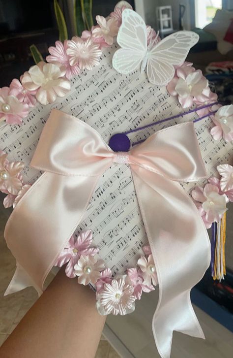 Pink graduation cap, coquette, flower and butterfly, bow Bow Graduation Cap, Graduation Cap Designs With Bow, Graduation Cap With Butterflies, Graduation Cap Designs Coquette, Coquette Graduation Cap, Graduation Cap Bow, Pink Graduation Cap, Pink Graduation, Flower And Butterfly